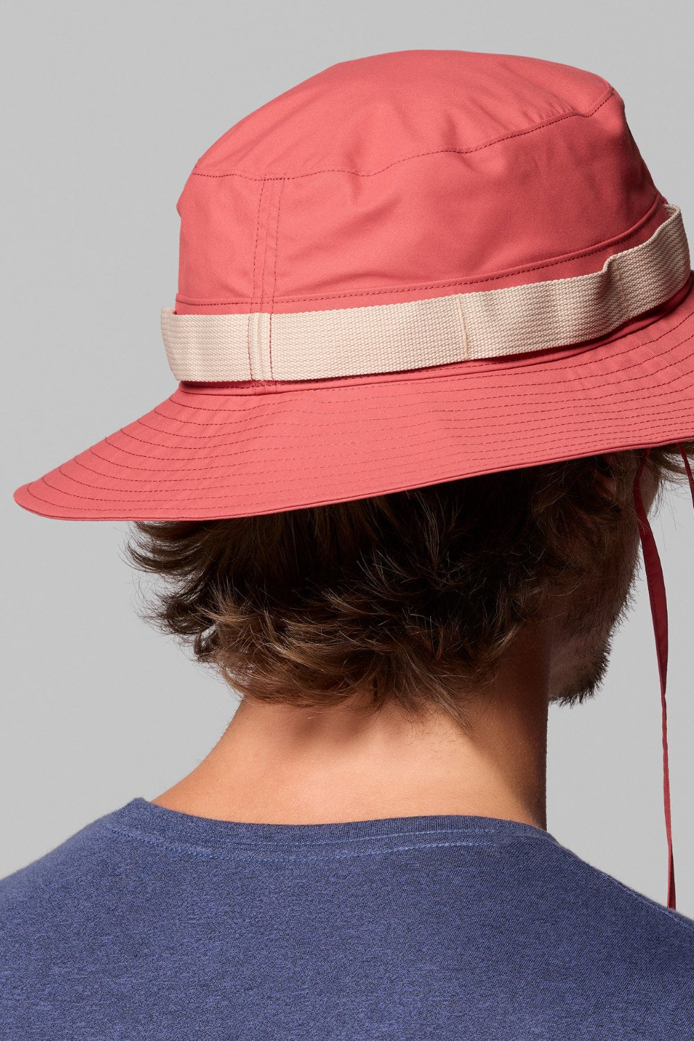 Bob anti-UV packable pour homme, en rouge, offrant protection solaire UPF 50+ pour activités extérieures.